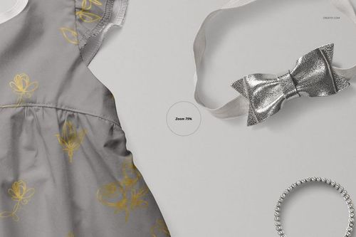 PSD mockup featuring a baby dress in gray with yellow flower motifs, displayed with a metallic bow and bracelet.