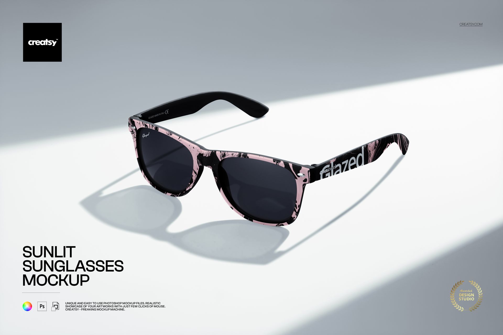 Front view of black sunglasses with pink marbled pattern on the frame, displayed on a light background in a mockup scene.