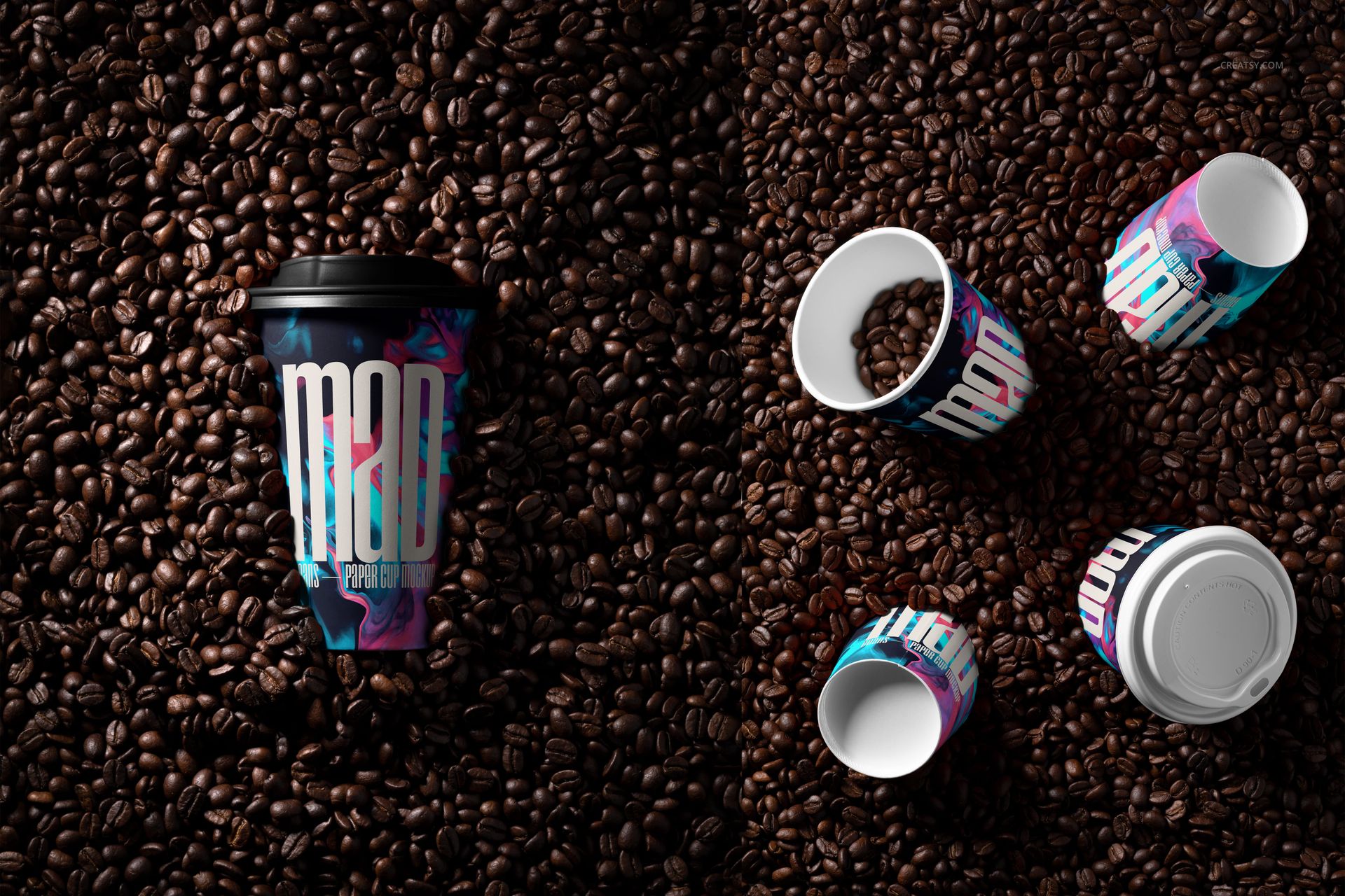 PSD mockup featuring multiple paper cups with vibrant patterns, placed among scattered coffee beans in overhead and angled views.