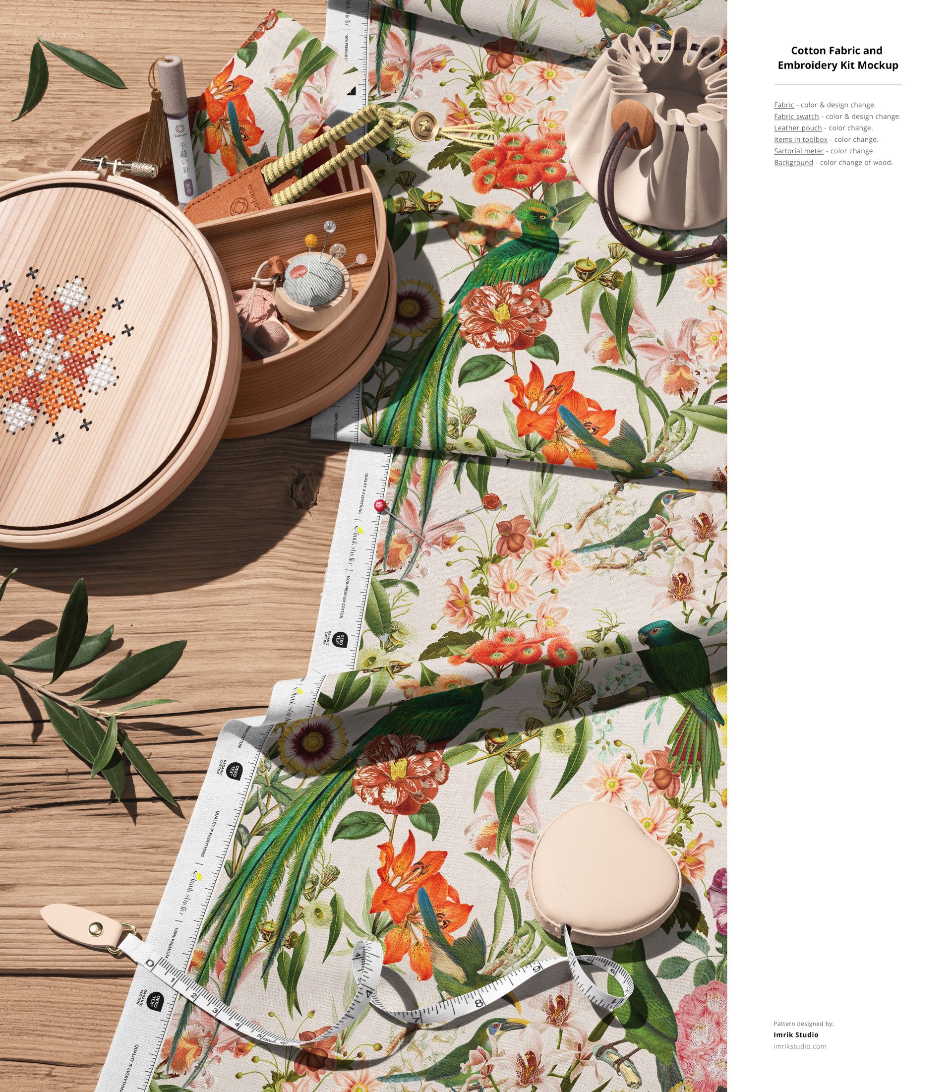 PSD mockup showing cotton fabric with vibrant flowers and birds, accompanied by sewing accessories and embroidery supplies.
