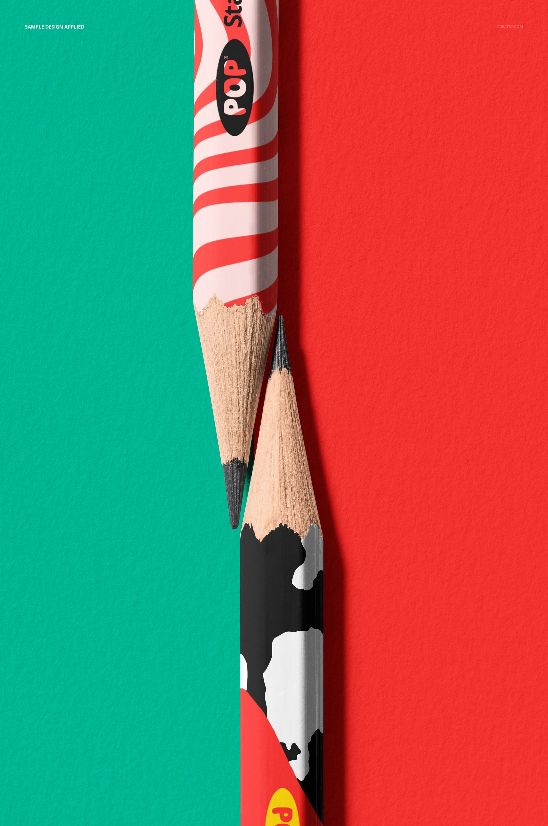 Two pencils mockup shown in a close-up, featuring colorful patterns and positioned on red and teal textured surfaces.