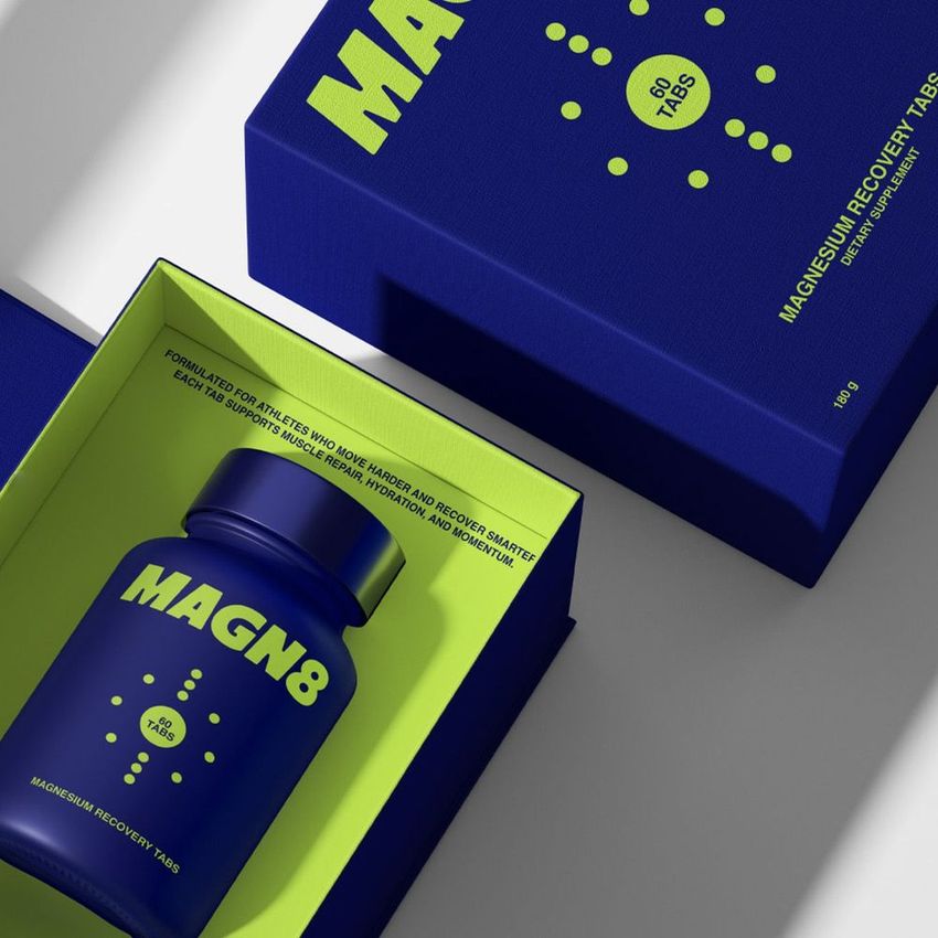 Cosmetics box packaging mockup featuring a blue and yellow capsule bottle and matching box with bold text, shown from above.