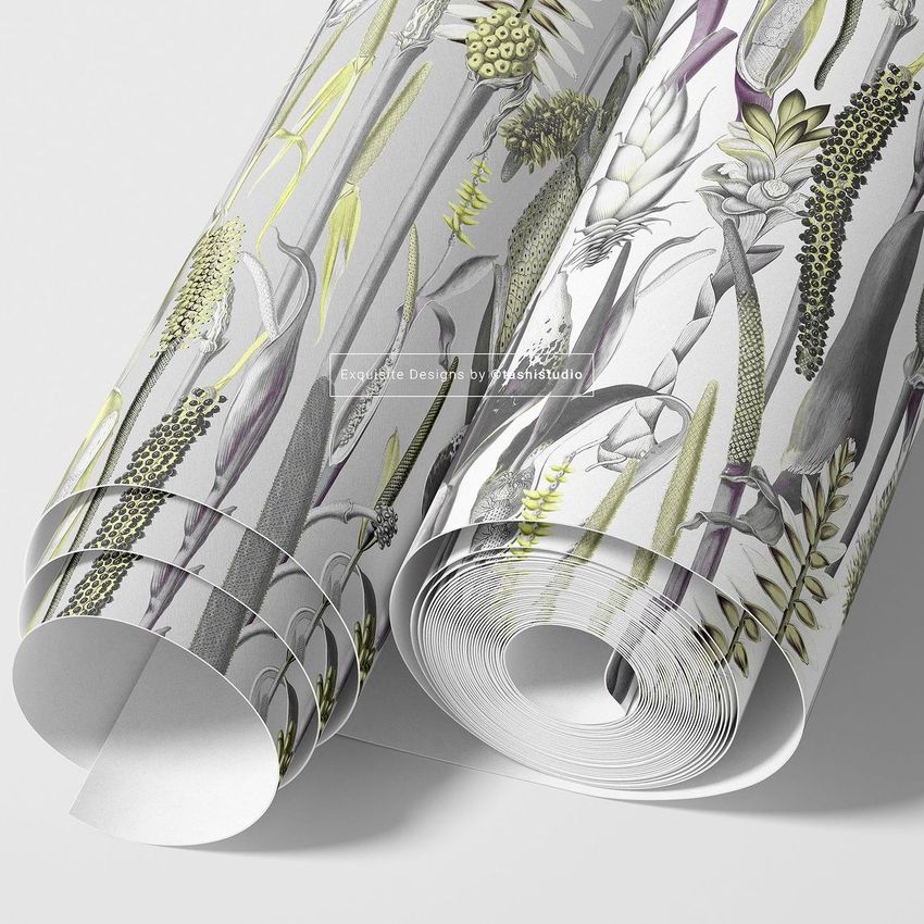 Paper wallpaper mockup featuring two rolled sheets with botanical illustrations in muted green, yellow, and gray tones on a light surface.