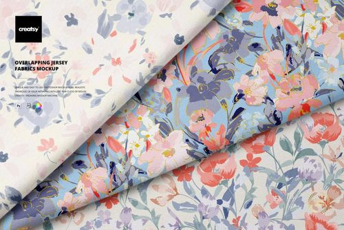 PSD mockup of overlapping fabric pieces with soft blue, pink, and orange floral prints, seen in close-up detail.