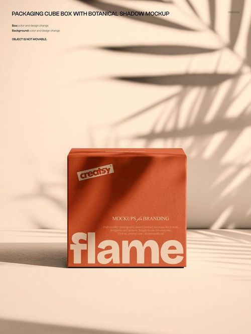 Orange cube box mockup with large white lettering, shown on a beige background with leaf shadows and sunlight.
