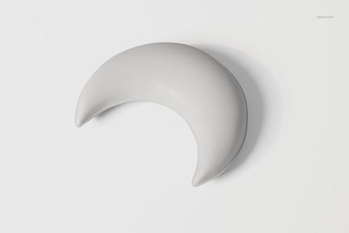 Crescent moon-shaped pillow in solid light gray color, displayed from a top view on a plain white background.