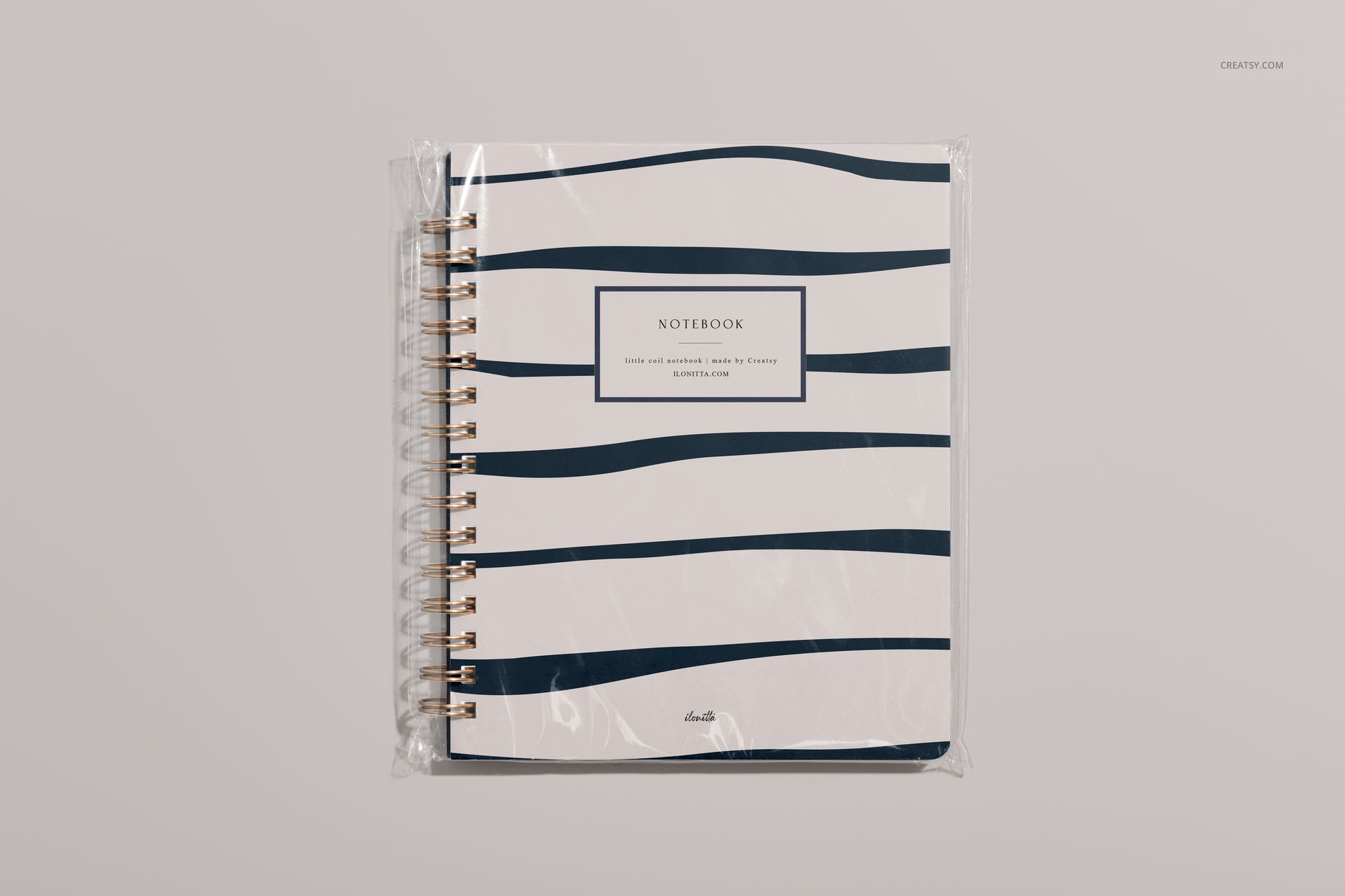 Front-facing little spiral notebook mockup with abstract navy wave pattern on white cover, clear plastic wrap visible.