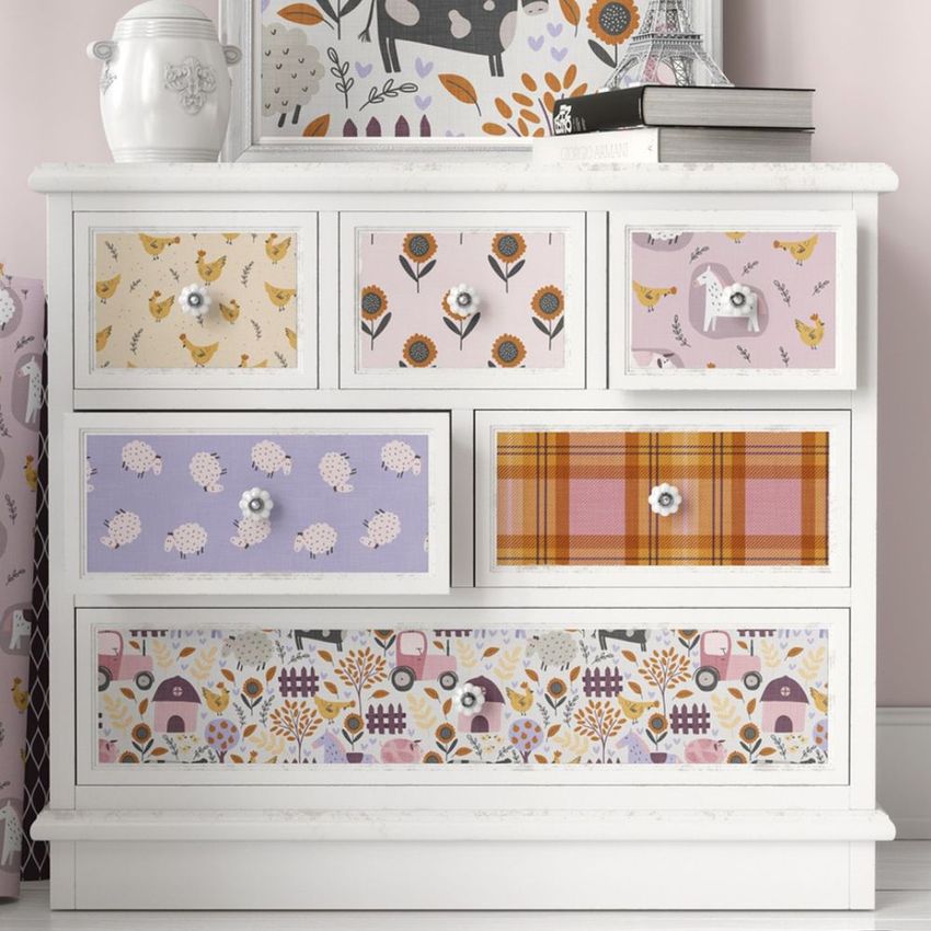 Decoupage furniture mockup featuring a white dresser with drawers decorated in farm-themed and patterned designs in pastel colors.