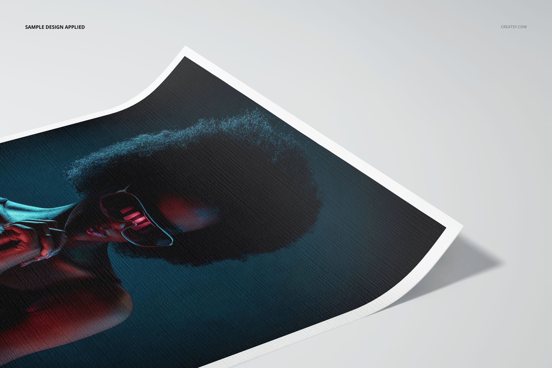 Canvas paper mockup displaying a close-up of a colorful portrait with textured surface and white border on a light background.