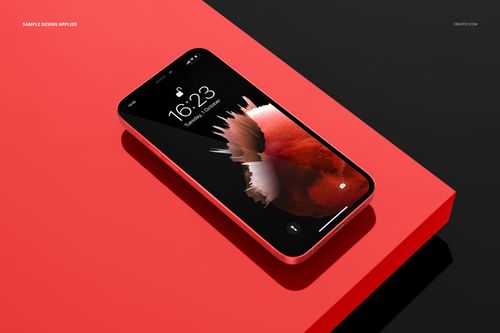 Angled perspective of an iPhone 12 mockup featuring a vivid display, placed on a glossy red rectangular surface.