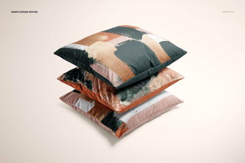 Front view of three velvet cushion covers featuring artistic abstract designs in earthy colors, shown in a mockup scene.
