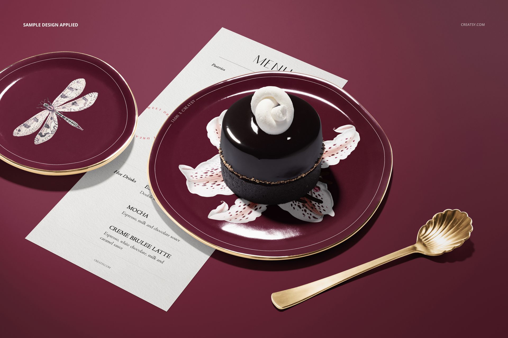 Round plate mockup with a burgundy background, featuring a dessert and floral pattern, top view with gold spoon.