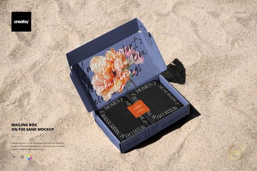 Open mailing box mockup displayed on sandy surface, featuring a black and orange design with visible inner artwork.