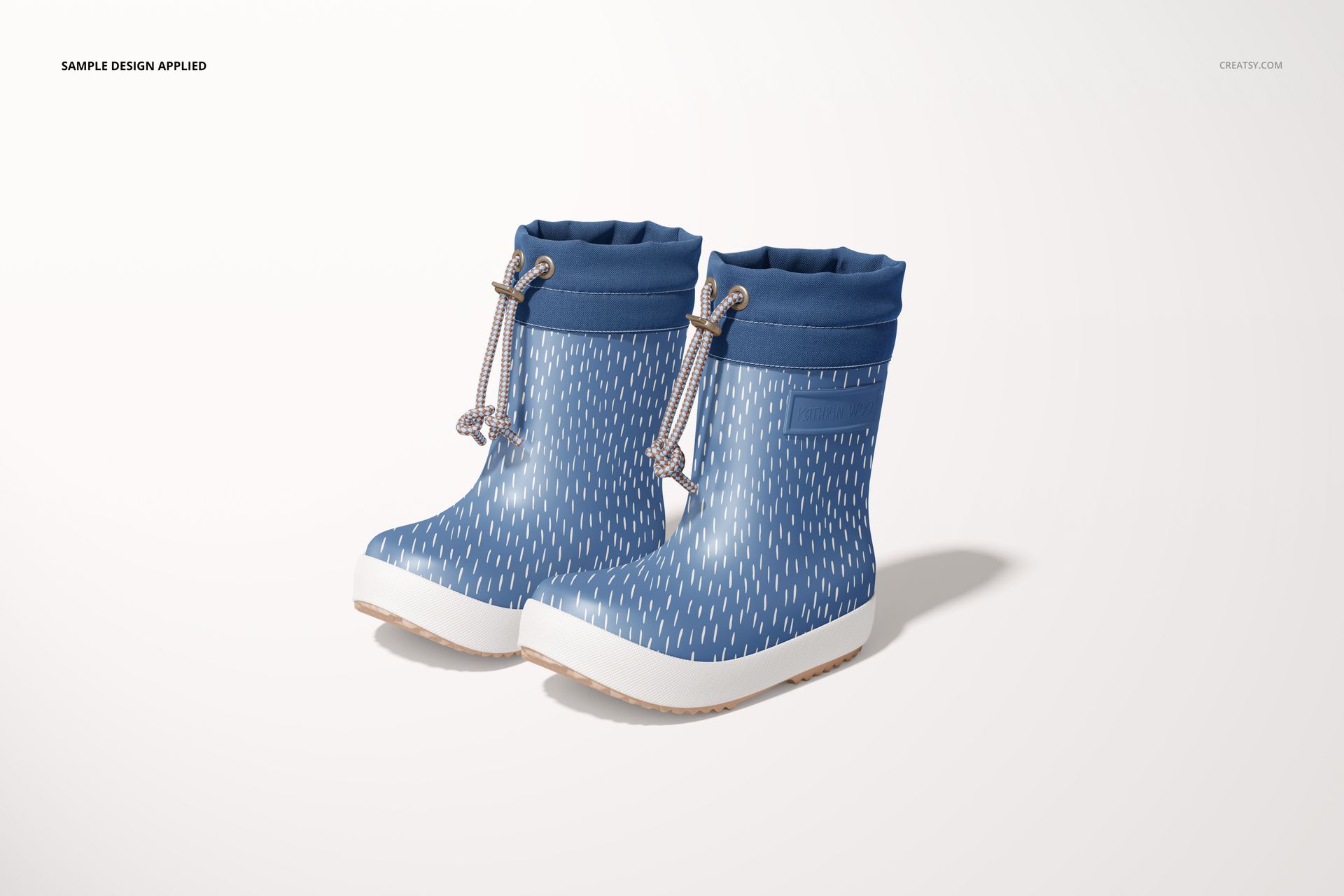 Children’s rain boots mockup featuring blue boots with a white dotted pattern, shown from a front side perspective.