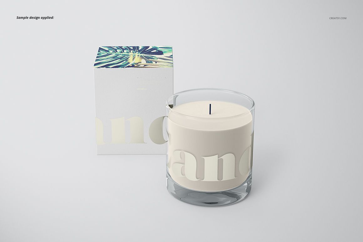 Classic candle mockup featuring a transparent glass jar and white candle, next to a box with botanical design.