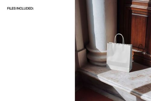 Paper shopping bag mockup featuring a plain white bag on marble steps, illuminated by natural light near architectural details.