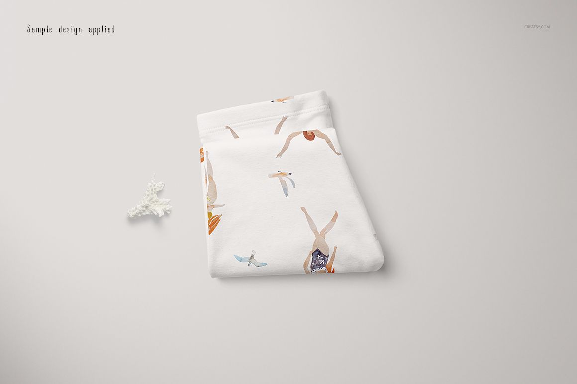 White baby leggings mockup featuring colorful illustrations of birds and children, shown folded on a neutral surface.