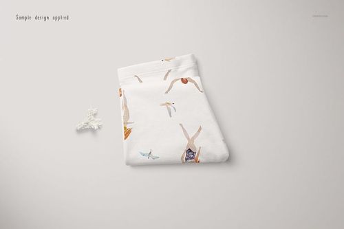 White baby leggings mockup featuring colorful illustrations of birds and children, shown folded on a neutral surface.