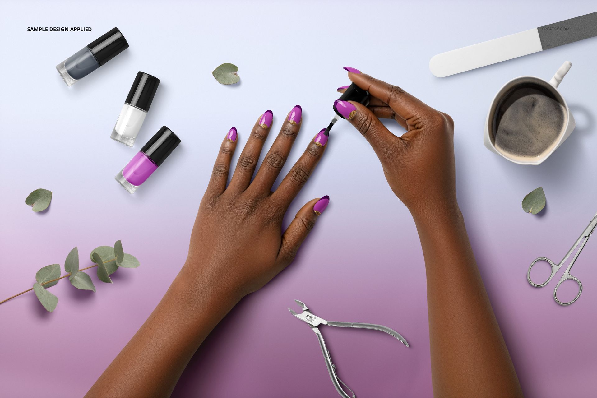 PSD mockup of a manicure scene showing a hand having nails painted purple, with nail care items and leaves nearby.