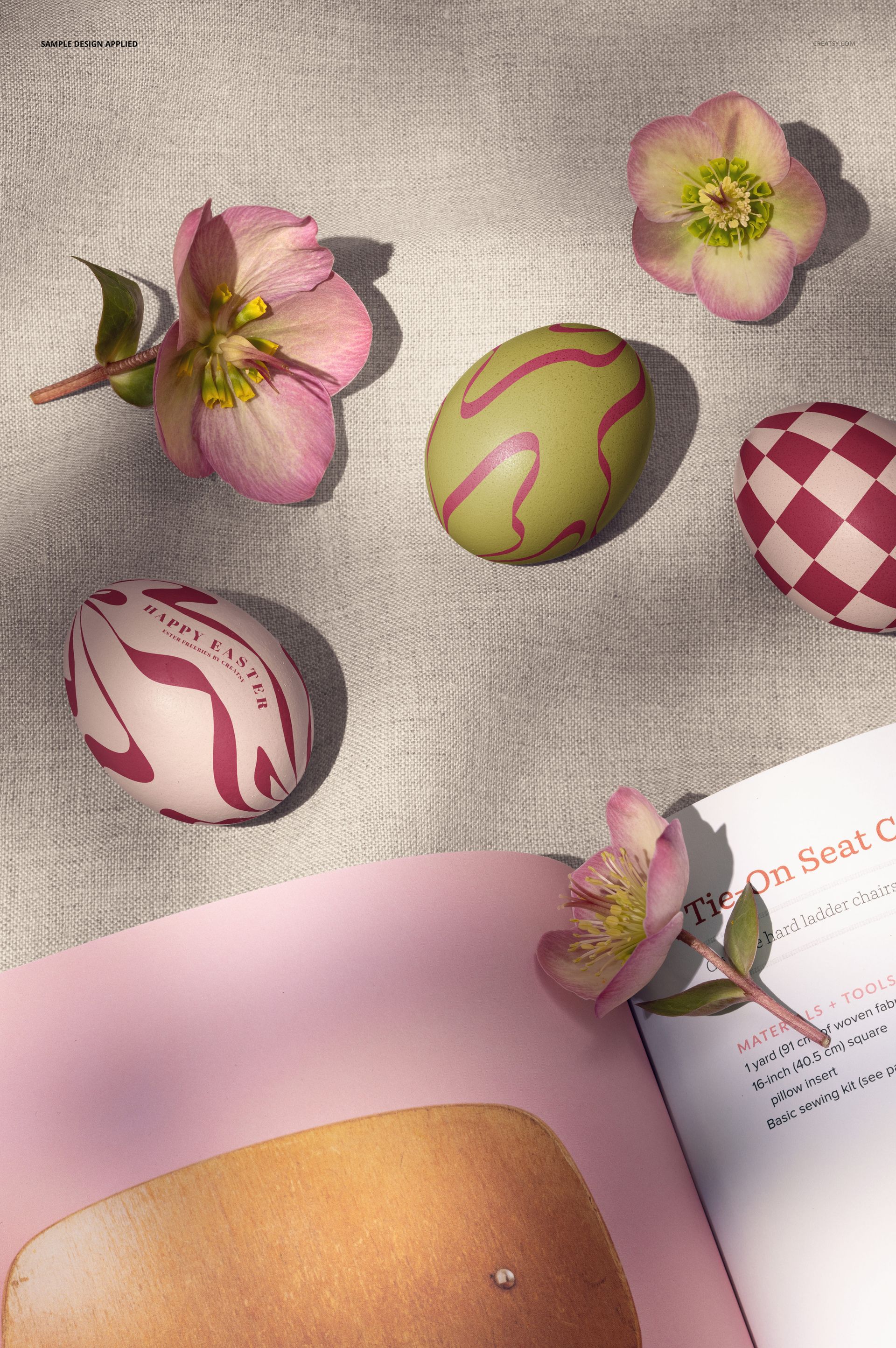 PSD mockup featuring patterned Easter eggs in pink and green alongside an open book and hellebore flowers.