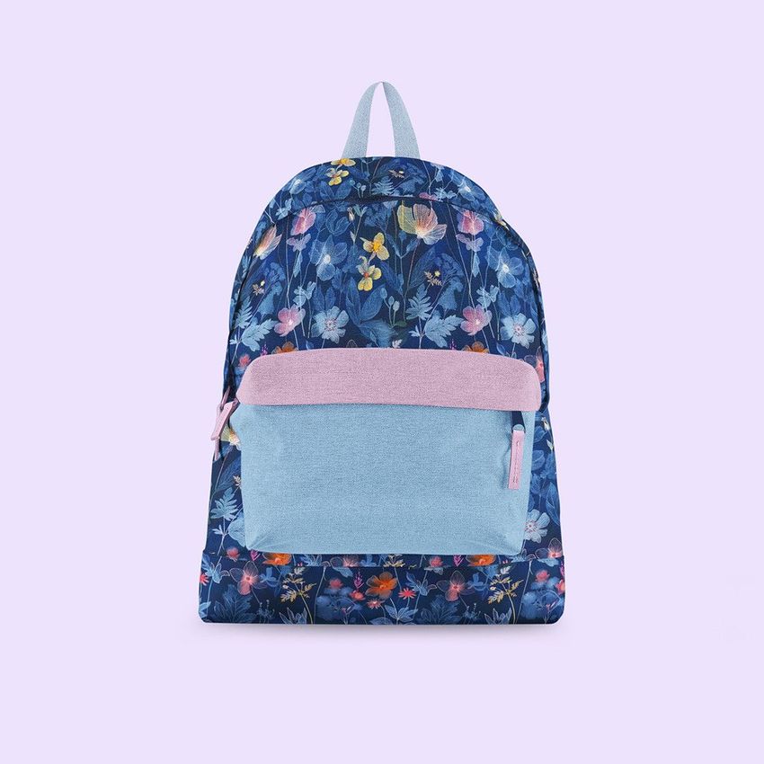 Backpack mockup featuring a blue floral pattern with a light blue pocket and pink accents, displayed on a pale lavender background.
