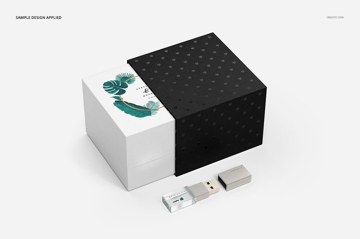 Acrylic USB drive slide box mockup set featuring a black sliding cover, white box with leaf design, and two USB drives.