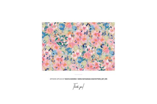 Cotton fabric mockup displayed from above, showing a vibrant floral design with leaves and multicolored blossoms.