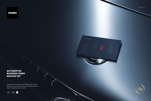 Dark business card mockup displayed on the hood of a metallic car, viewed from above with soft lighting.