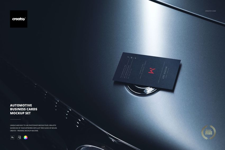 Dark business card mockup displayed on the hood of a metallic car, viewed from above with soft lighting.