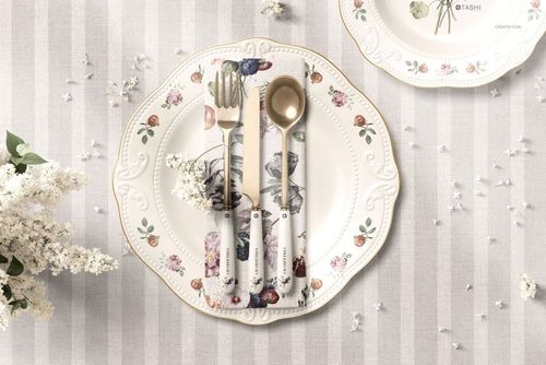 Classic placemat napkin and plate mockup featuring floral-patterned tableware, top view on striped fabric.