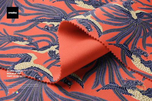 Scuba fabric mockup featuring a folded textile with a bold orange background and intricate bird pattern in blue and beige.