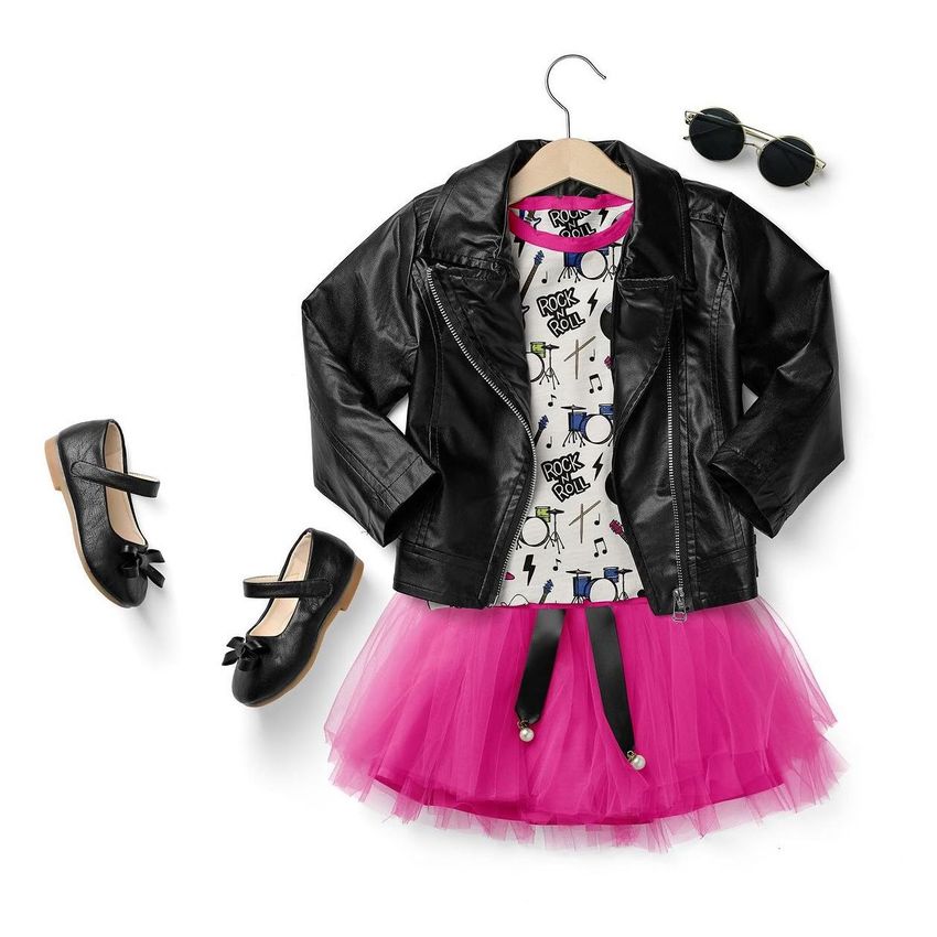Flat lay of a girls chic set mockup featuring a black faux leather jacket, pink tulle skirt, graphic tee, black shoes, and sunglasses on a white background.