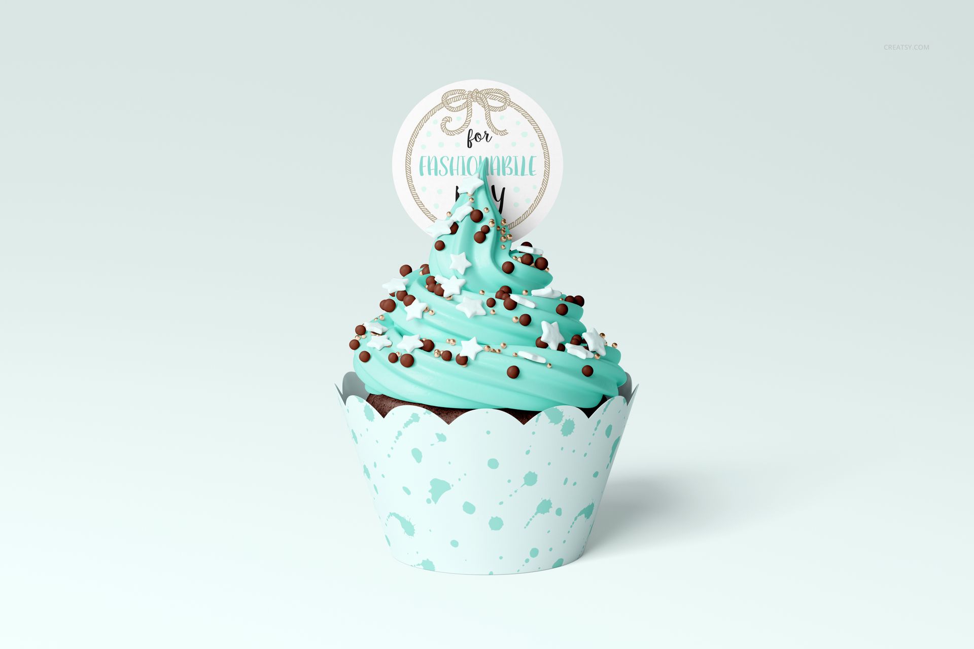 PSD mockup of a cupcake featuring blue icing, chocolate sprinkles, and a circular topper in a blue wrap.