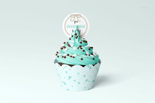 PSD mockup of a cupcake featuring blue icing, chocolate sprinkles, and a circular topper in a blue wrap.