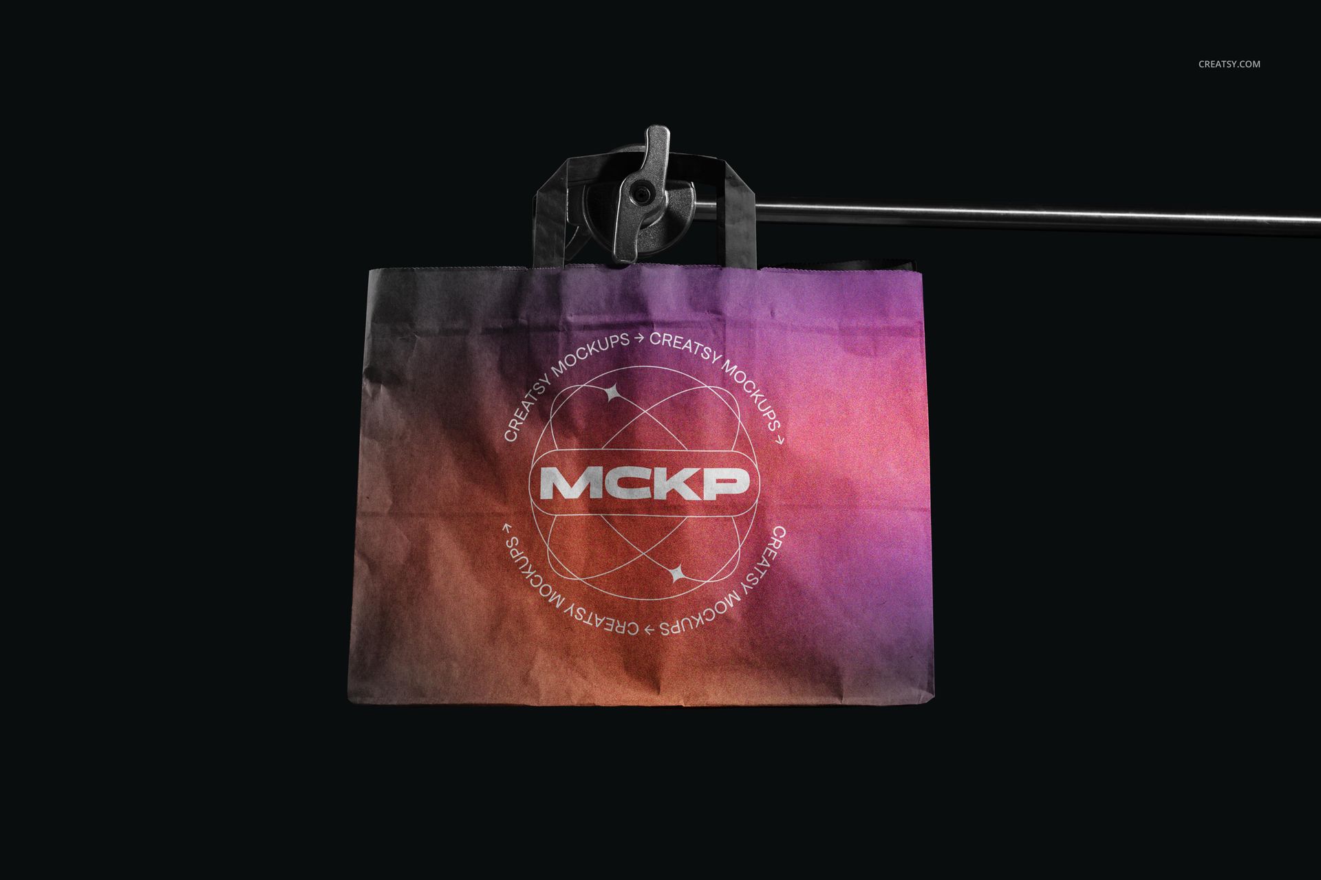 Front view of a flat handles paper bag mockup displaying a vibrant gradient pattern on a black studio backdrop.