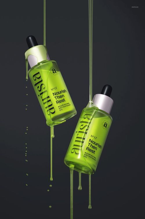 Two green dropper bottles with black caps suspended against a dark background, liquid dripping from each bottle.