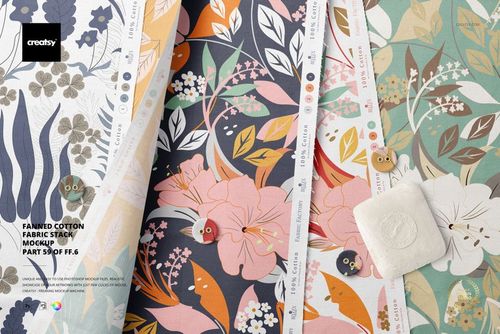 Cotton fabric stack mockup featuring multiple folded pieces with botanical designs in muted tones, top perspective.