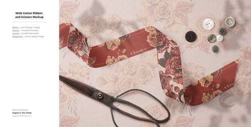Top view of a fabric mockup scene with wide cotton ribbon, scissors, and assorted buttons on a floral-patterned textile.