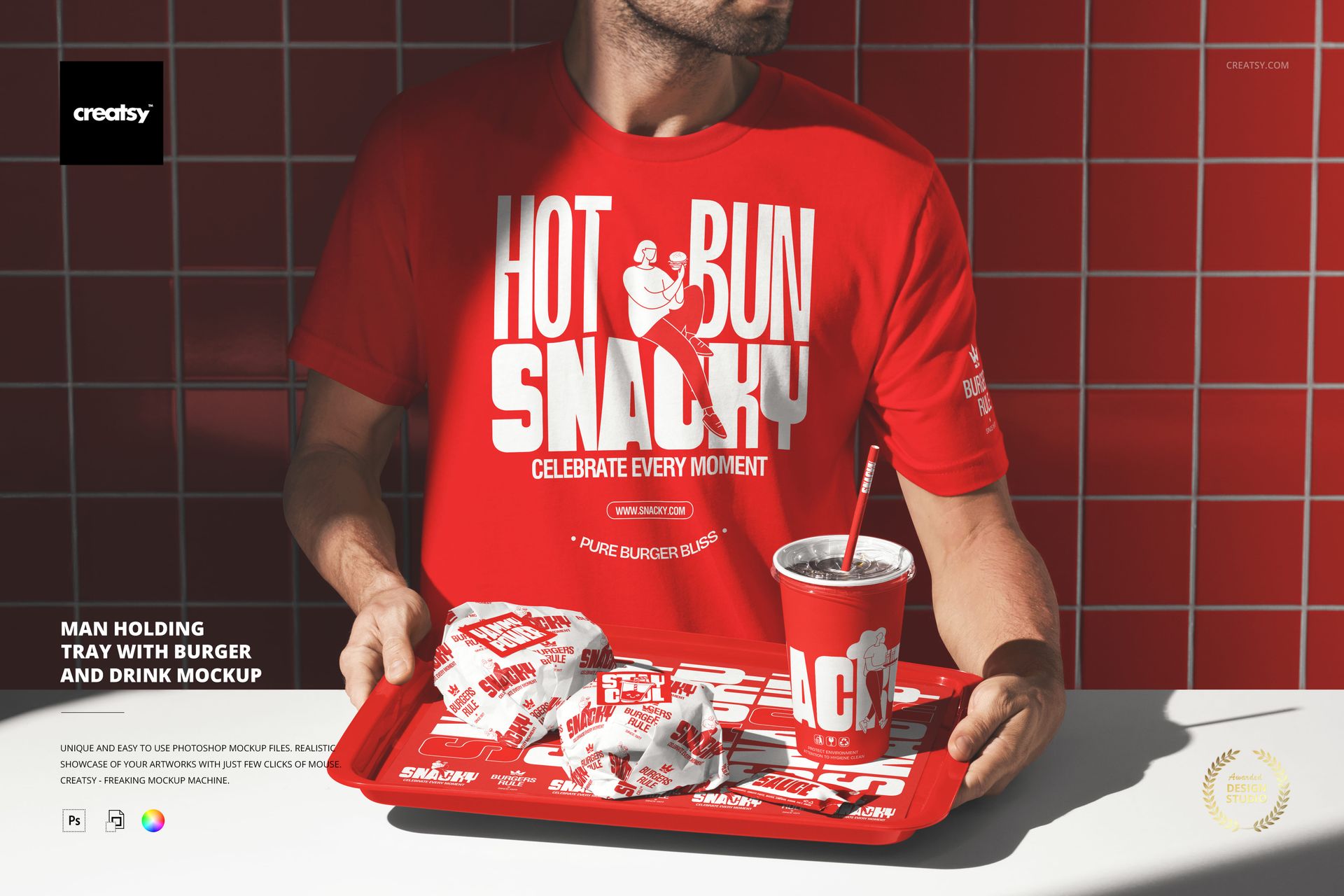 Man in a red t-shirt holding a red tray with wrapped burgers, fries, and a drink in a fast food themed mockup scene.
