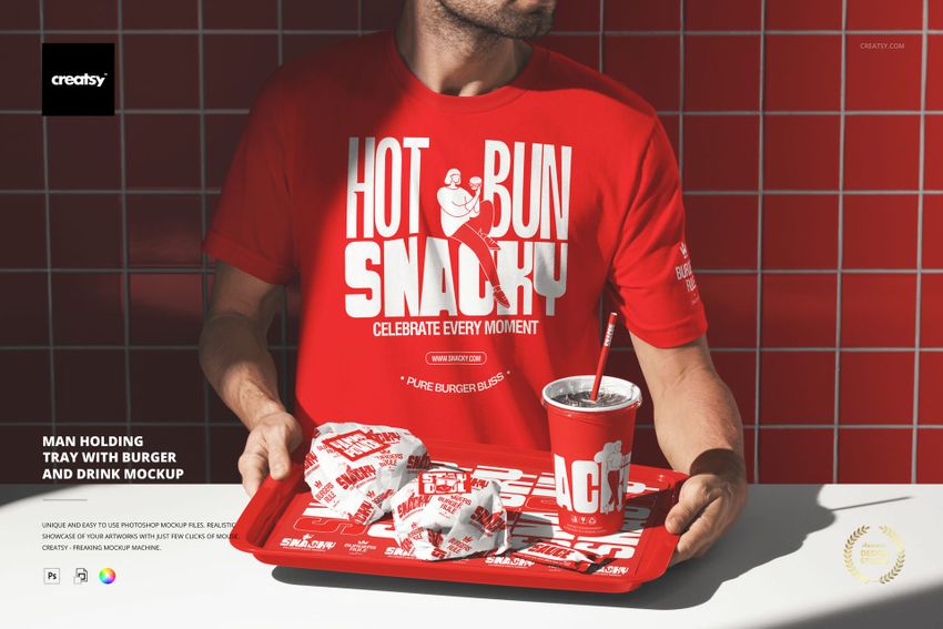 Man in a red t-shirt holding a red tray with wrapped burgers, fries, and a drink in a fast food themed mockup scene.