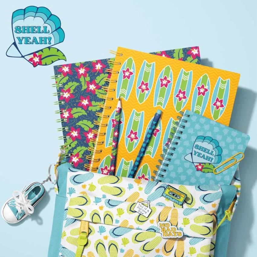 School backpack mockup with spiral notebooks featuring colorful surfboard and floral patterns, pens, and a small sneaker keychain.