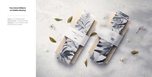 Flat lay of two fabric mockup paddles featuring black and white botanical prints, surrounded by scattered leaves and petals.