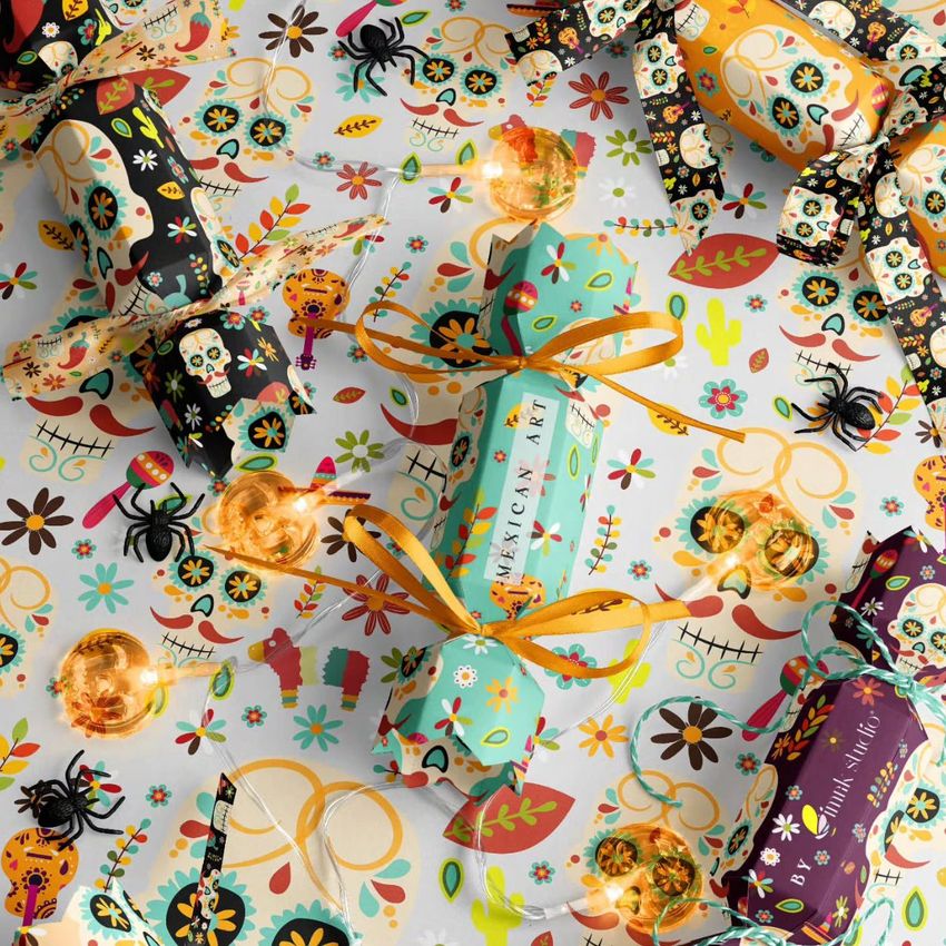 Halloween party cracker packaging mockup featuring colorful crackers with Mexican-inspired patterns and festive motifs on a patterned surface.