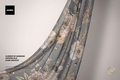 Close-up view of a hanging chiffon silk scarf mockup featuring a delicate floral pattern on a soft gray background.