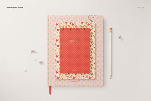 Top view of a stationery mockup bundle featuring a red spiral notebook, floral folder, and white pencil on a desk.