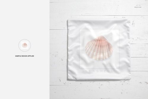 Square polyester throw pillow with a seashell design, displayed on a white wooden surface, front view mockup.