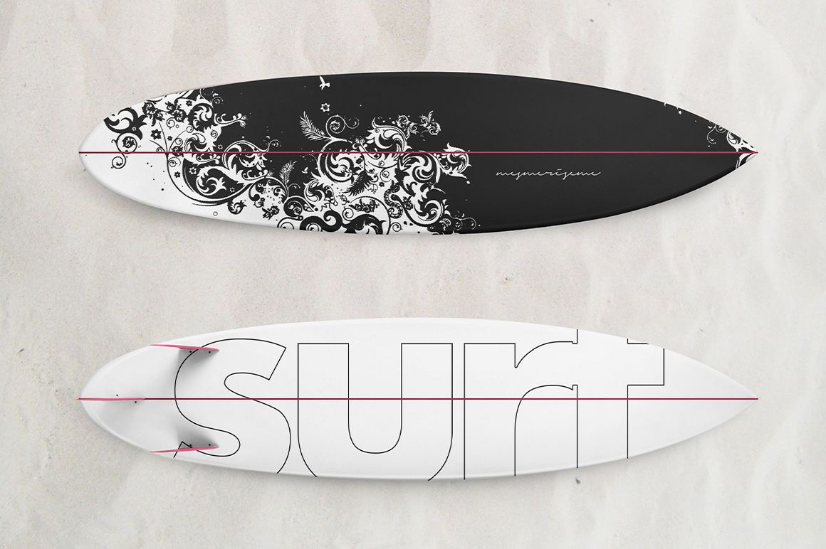 Surfboard PSD mockup showing two boards on sand, one with a dark ornate pattern and one with bold outlined text.