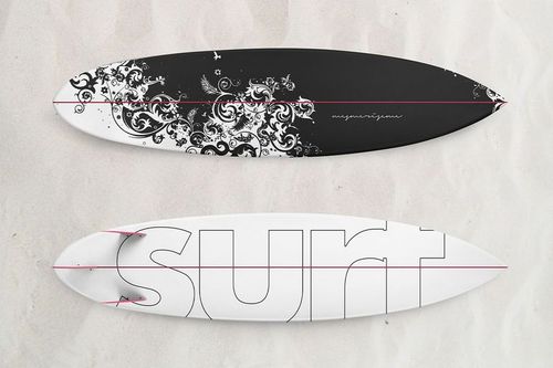 Surfboard PSD mockup showing two boards on sand, one with a dark ornate pattern and one with bold outlined text.