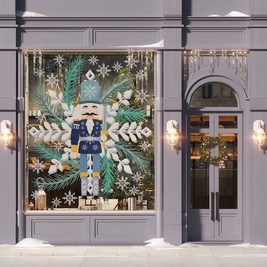 Christmas storefront mockup featuring a large nutcracker illustration on the window, surrounded by snowflakes and evergreen branches.