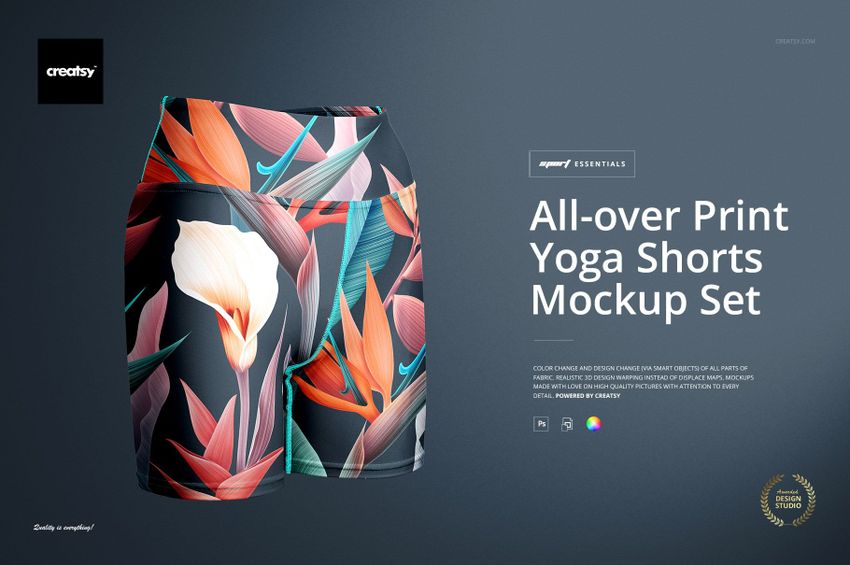 Front view of yoga shorts with an all-over floral print in orange, green, and white on a dark background, mockup set.